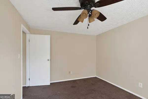an empty room with ceiling fan