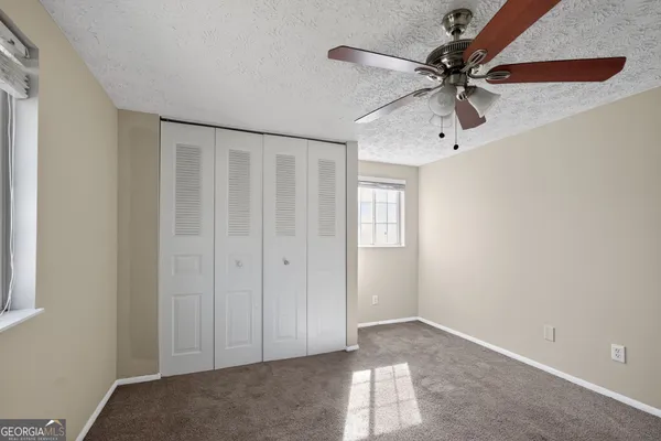 a view of a livingroom with a chandelier fan