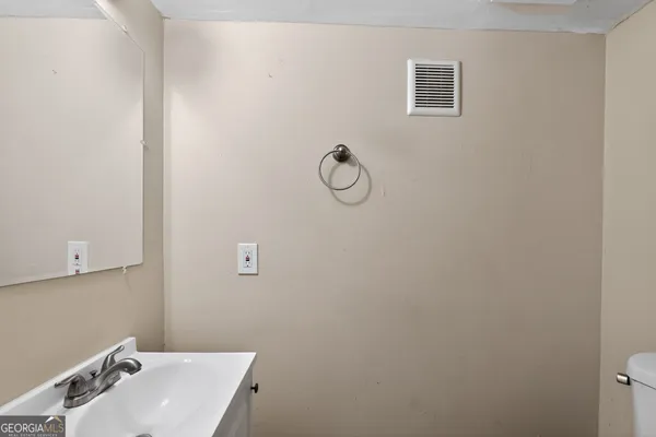 a bathroom with a sink and mirror