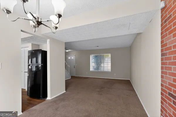 a view of empty room with windows and ceiling fan