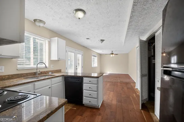 a kitchen with a sink stove and refrigerator