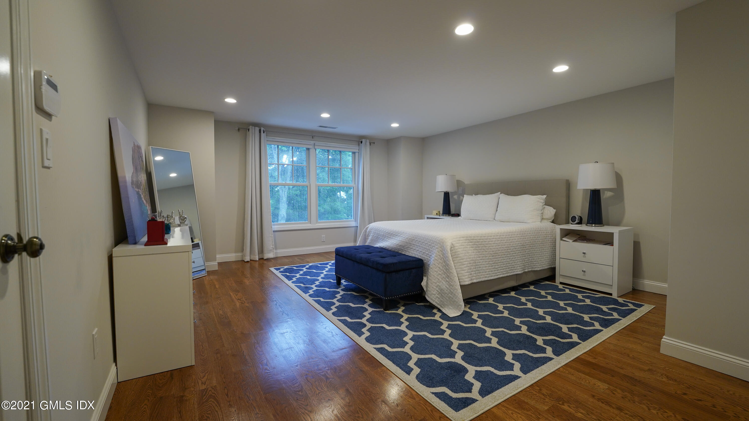 20 Sunshine Avenue Riverside, CT 06878 - Photo 25 of 39 a bedroom with a bed and wooden floor