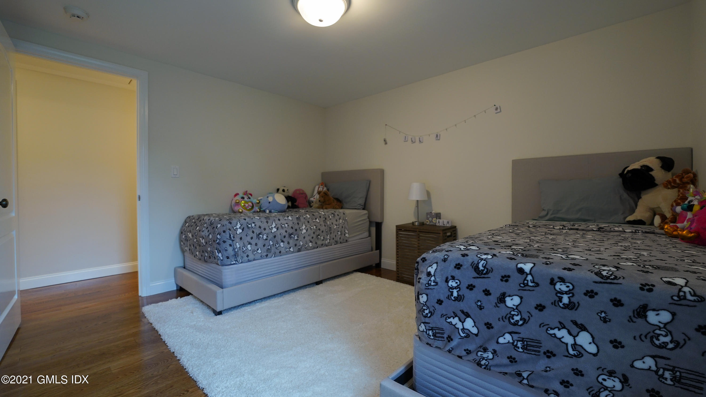 20 Sunshine Avenue Riverside, CT 06878 - Photo 32 of 39 a bedroom with a bed and wooden floor