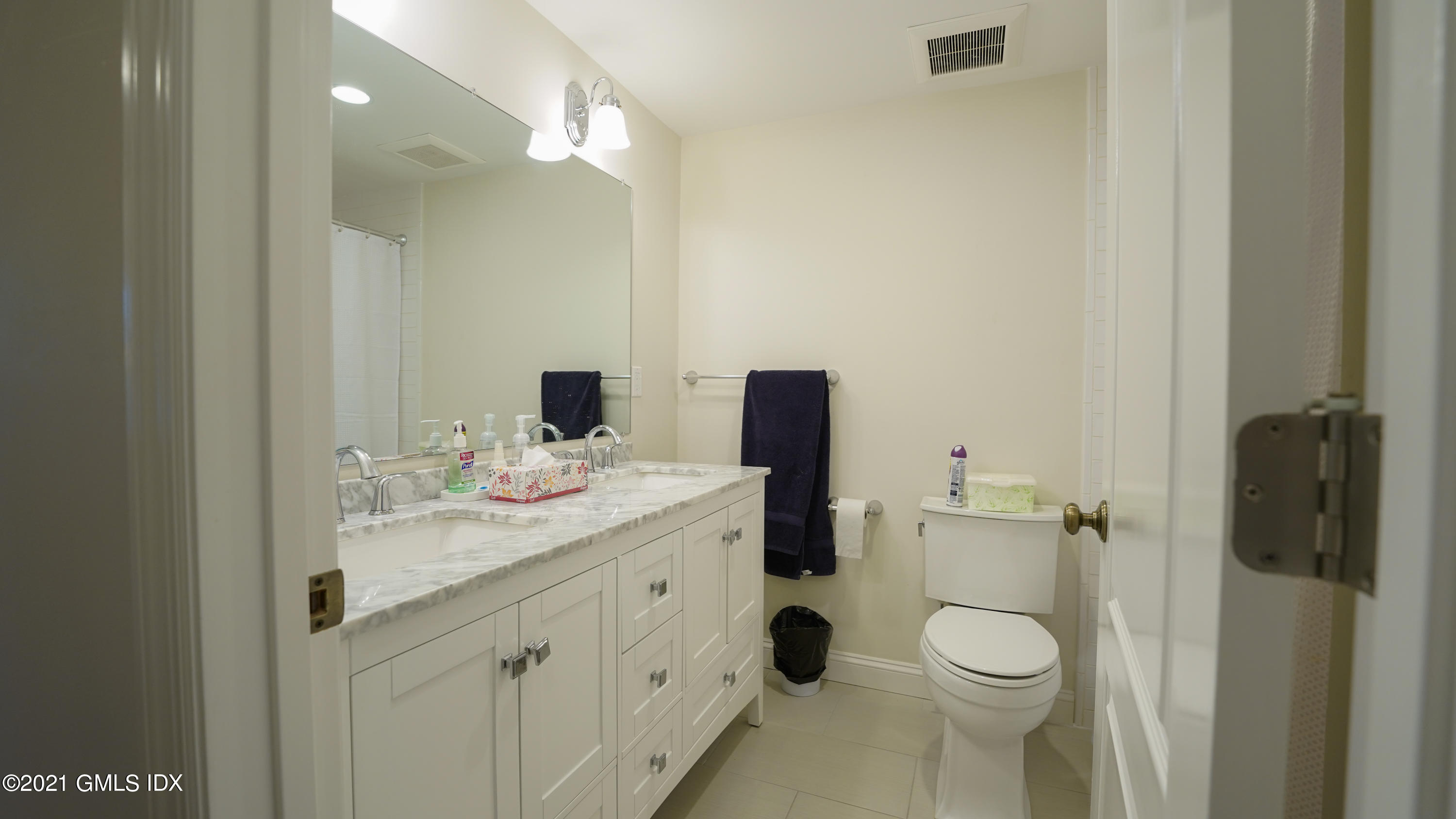 20 Sunshine Avenue Riverside, CT 06878 - Photo 34 of 39 a bathroom with a granite countertop sink a toilet and a mirror