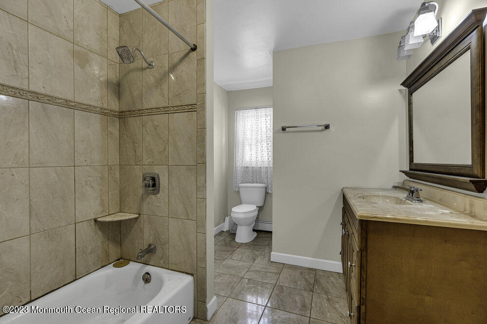 77 Farrington Road Old Bridge, NJ 07747 - Photo 14 of 33 a bathroom with a granite countertop sink a toilet and a shower