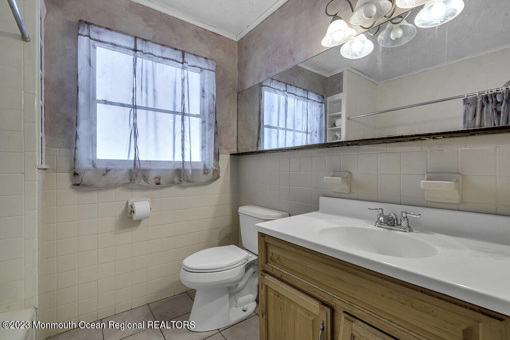 77 Farrington Road Old Bridge, NJ 07747 - Photo 21 of 33 a bathroom with a sink a toilet and a mirror