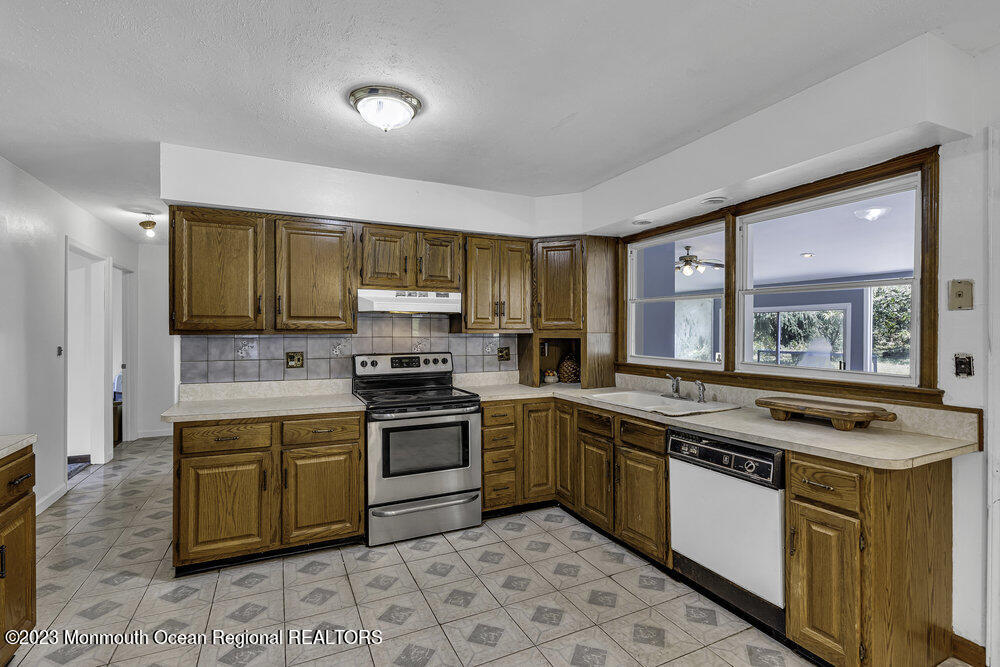 77 Farrington Road Old Bridge, NJ 07747 - Photo 8 of 33 a kitchen with stainless steel appliances granite countertop a stove a sink dishwasher and a refrigerator