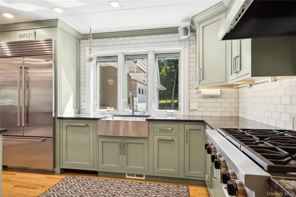 a kitchen with stainless steel appliances granite countertop a stove and a refrigerator