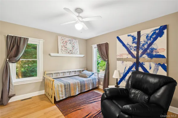 a bedroom with a bed couch and a window