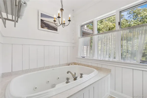a bathroom with a bathtub and a window