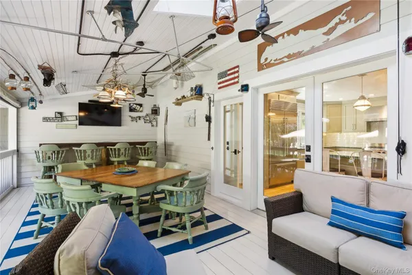 a view of a dining room with furniture a chandelier and wooden floor