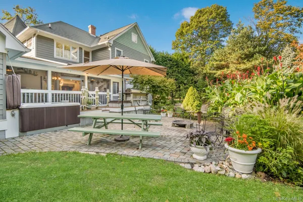 a view of a chair and table in backyard of the house