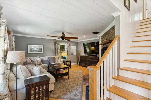 a living room with furniture and stairs