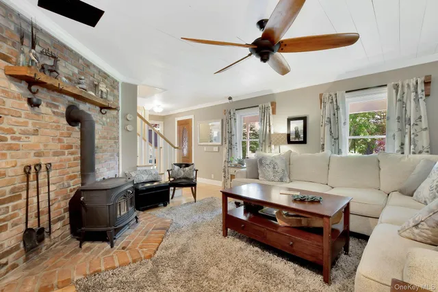 a kitchen with stainless steel appliances granite countertop white cabinets and a stove a oven with wooden floors