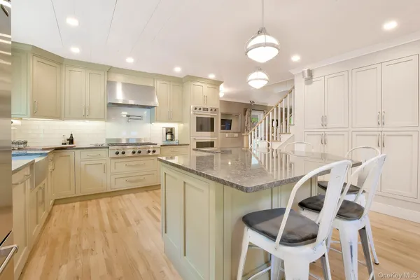 a kitchen with stainless steel appliances granite countertop a sink counter space and cabinets