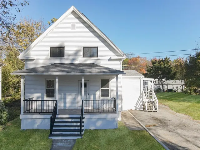 a view of a house with pool and a yard