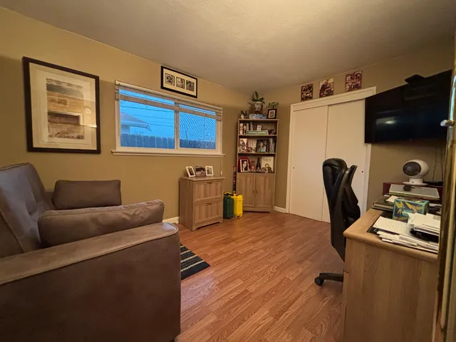 a livingroom with workspace and a couch