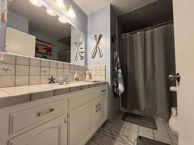 a bathroom with a double vanity sink and mirror