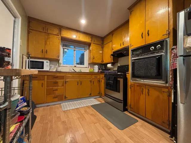 a kitchen with stainless steel appliances kitchen island granite countertop a stove a sink and dishwasher