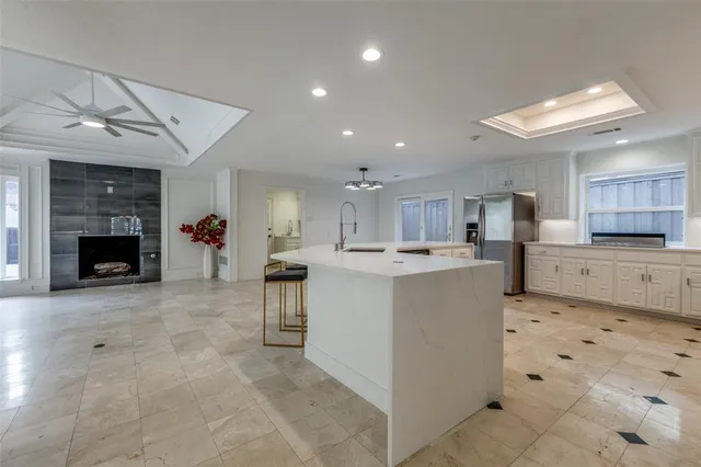 a view of kitchen with cabinets microwave and stove