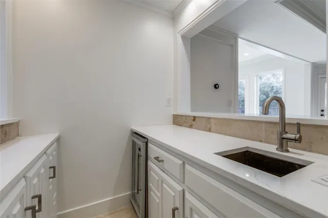a close view of a sink and dishwasher with kitchen island