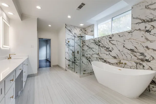 a bathroom with a bathtub and shower