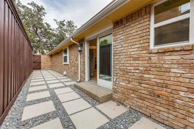 an aerial view of a house with a backyard