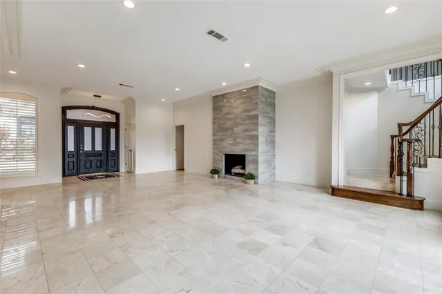 an empty room with fireplace and windows