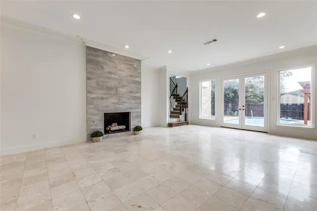 a view of an empty room with a fireplace and a large window