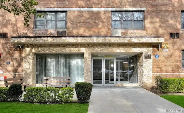 front view of a brick house with a yard