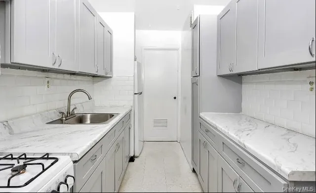 a view of a kitchen sink and cabinets