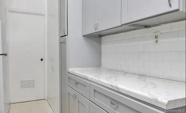 a dining room with wooden floor a chandelier a wooden table and chairs