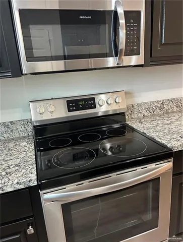 a stove top oven sitting inside of a kitchen