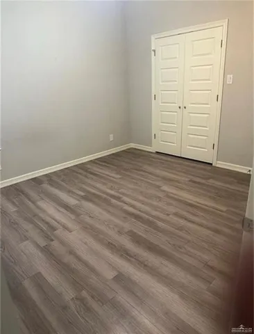 an empty room with wooden floor