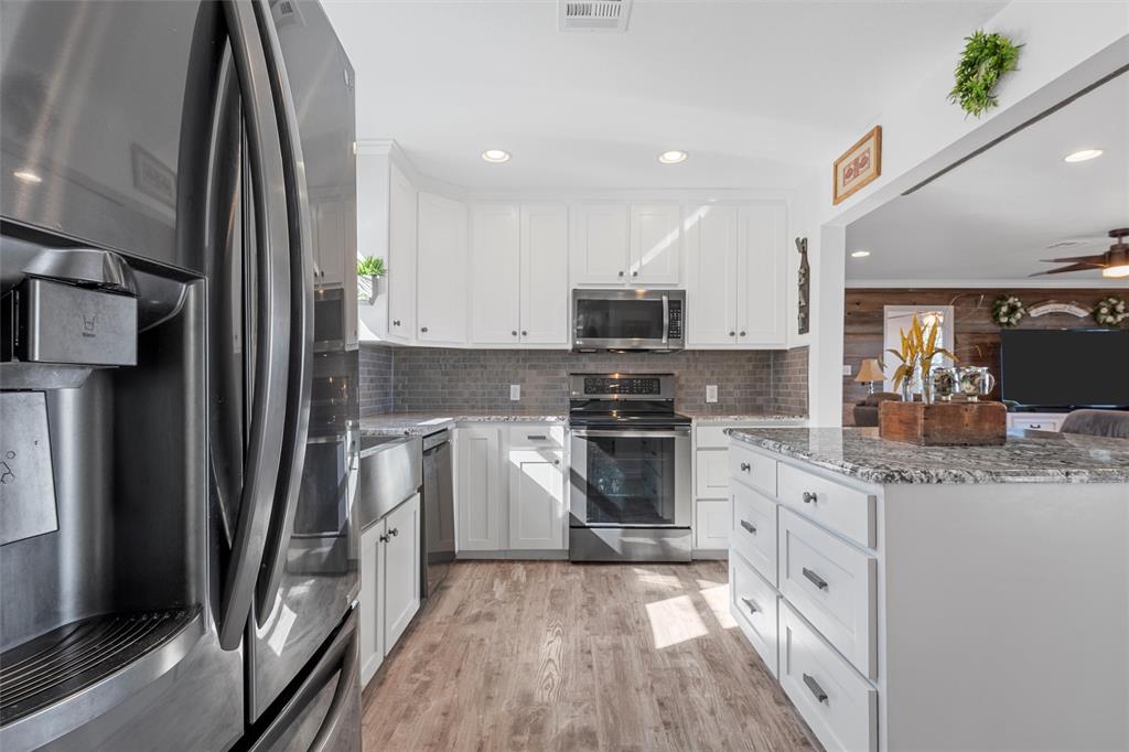 1307 Range Road China Spring, TX 76633 - Photo 12 of 40 a kitchen with stainless steel appliances a refrigerator sink and stove
