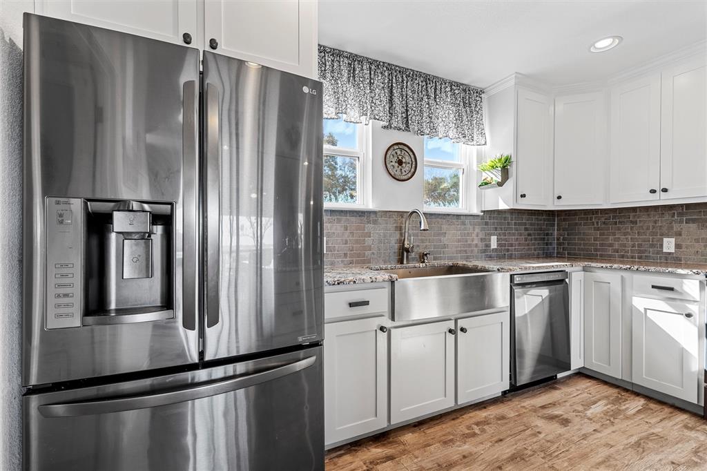 1307 Range Road China Spring, TX 76633 - Photo 14 of 40 a kitchen with stainless steel appliances granite countertop a refrigerator and a stove