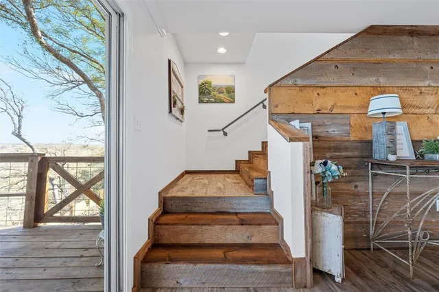 a view of entryway with wooden floor and a front door
