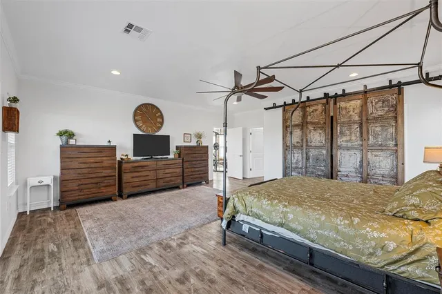 a bed sitting in a spacious bedroom next to a window