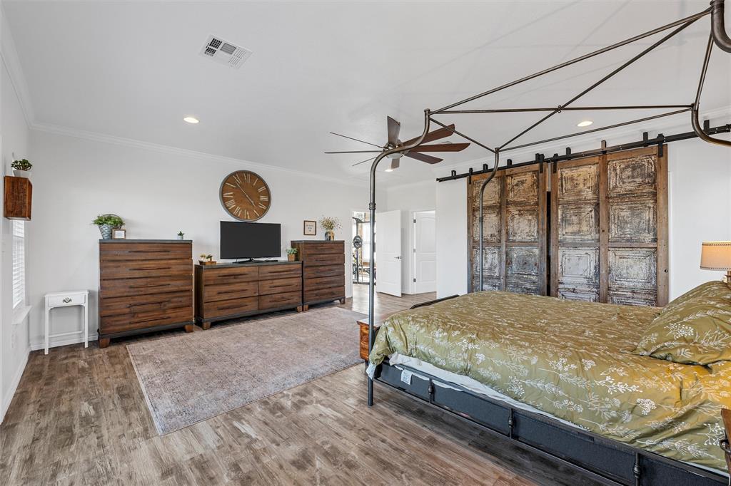 1307 Range Road China Spring, TX 76633 - Photo 17 of 40 a bed sitting in a spacious bedroom next to a window