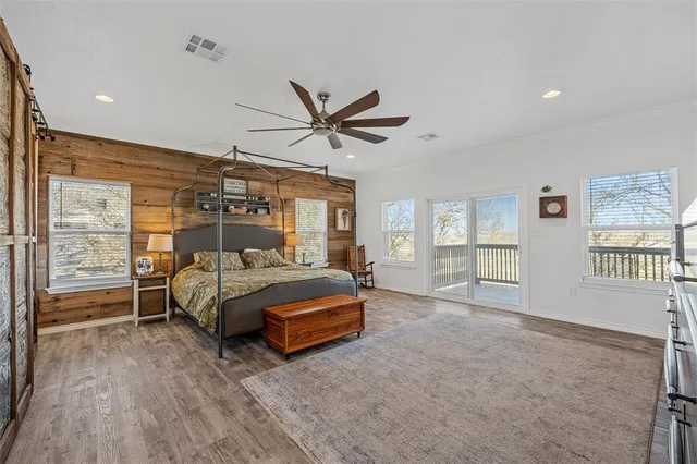 a bedroom with a bed and a large window