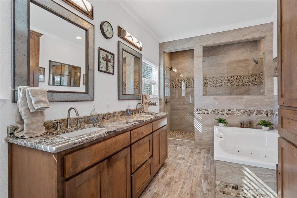 1307 Range Road China Spring, TX 76633 - Photo 19 of 40 a bathroom with a granite countertop sink a mirror a vanity and a bathtub
