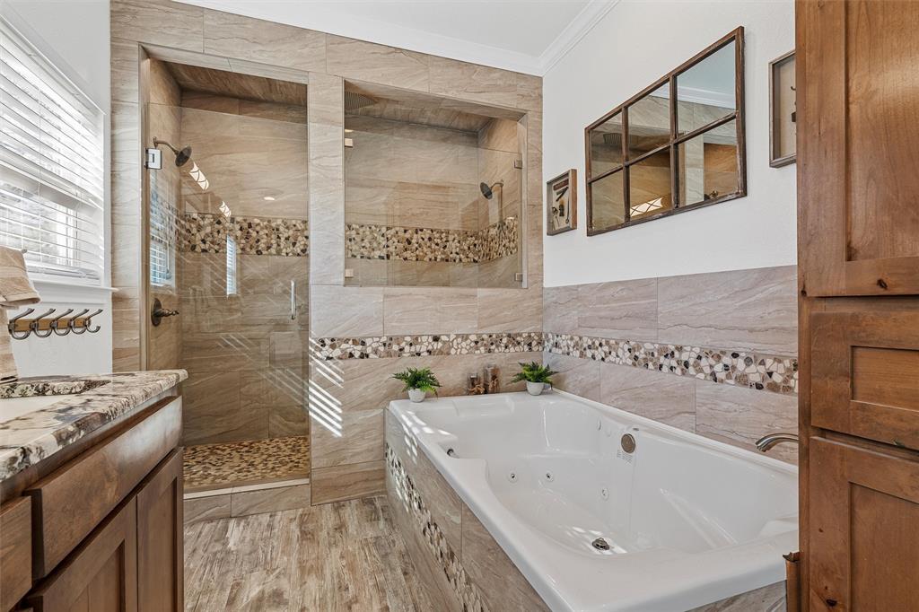 1307 Range Road China Spring, TX 76633 - Photo 20 of 40 a bathroom with a granite countertop sink a mirror and a bathtub