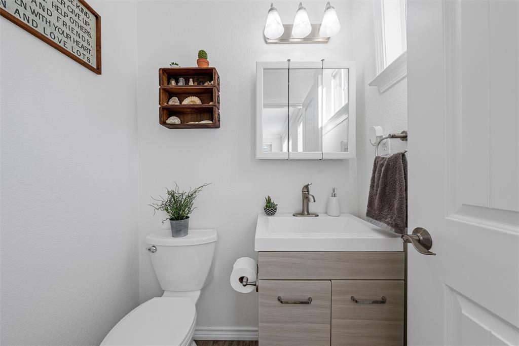 1307 Range Road China Spring, TX 76633 - Photo 26 of 40 a bathroom with a toilet sink and mirror