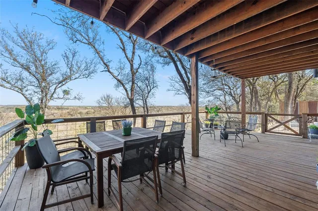 a view of a patio with table and chairs and wooden floor