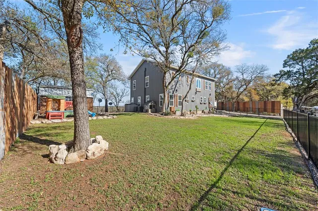 a large yard with lots of green space and trees