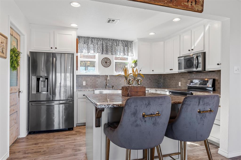 1307 Range Road China Spring, TX 76633 - Photo 10 of 40 a kitchen with stainless steel appliances granite countertop a refrigerator a stove a sink and a microwave