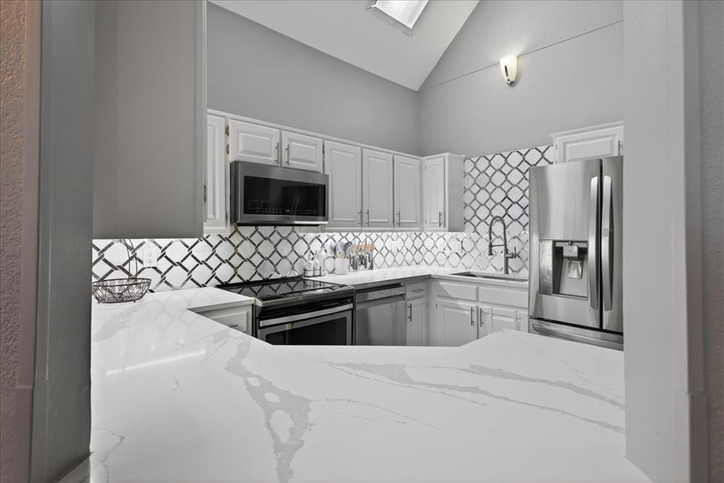 2934 North Bend Drive Dallas, TX 75229 - Photo 12 of 30 a kitchen with granite countertop a refrigerator stove and sink