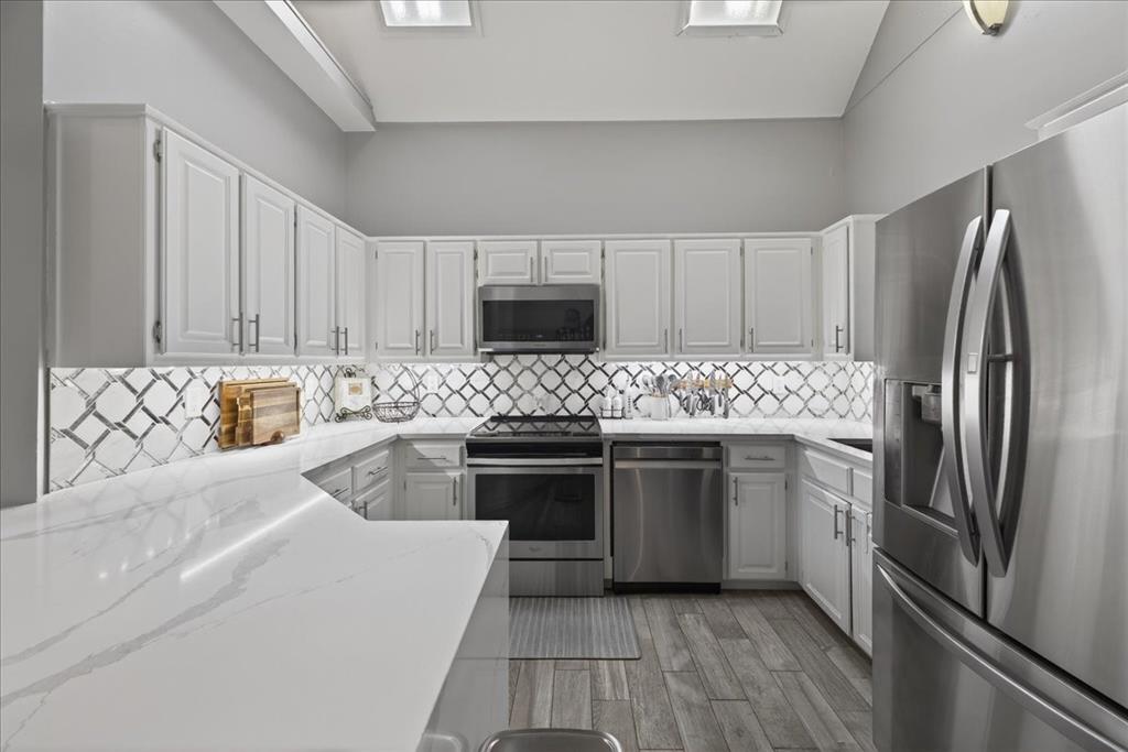 2934 North Bend Drive Dallas, TX 75229 - Photo 14 of 30 a kitchen with stainless steel appliances granite countertop a refrigerator stove top oven and sink