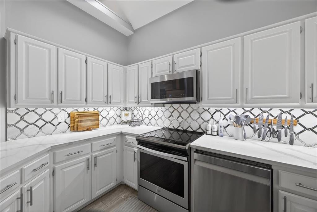 2934 North Bend Drive Dallas, TX 75229 - Photo 15 of 30 a kitchen with stainless steel appliances granite countertop white cabinets and sink