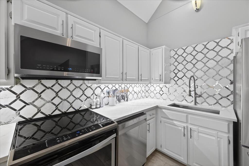 2934 North Bend Drive Dallas, TX 75229 - Photo 16 of 30 a kitchen with a sink stove and cabinets